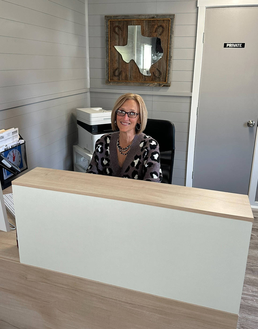 Texas Star RV Community manager Tanya Ott sitting at her desk.